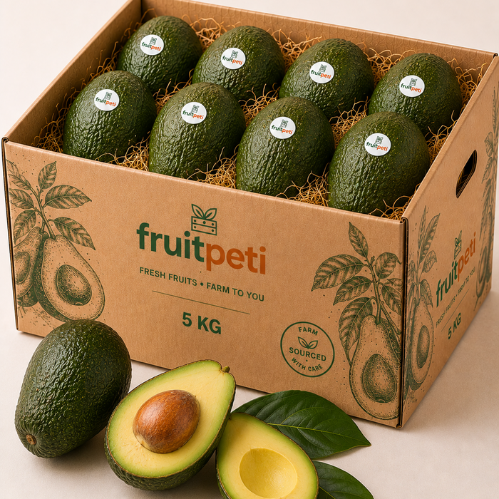 A 5 kg cardboard box of FruitPeti avocados filled with straw, with several whole and halved avocados placed in front on a light beige background.