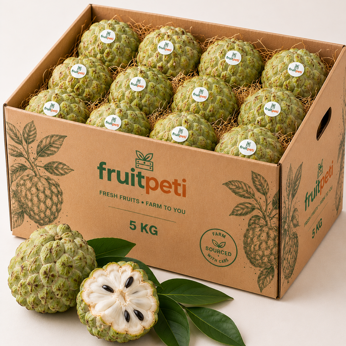 A 5 kg cardboard box filled with green custard apples, with two whole and one halved fruit in the foreground on a light beige background. The box is branded 'fruitpeti'.