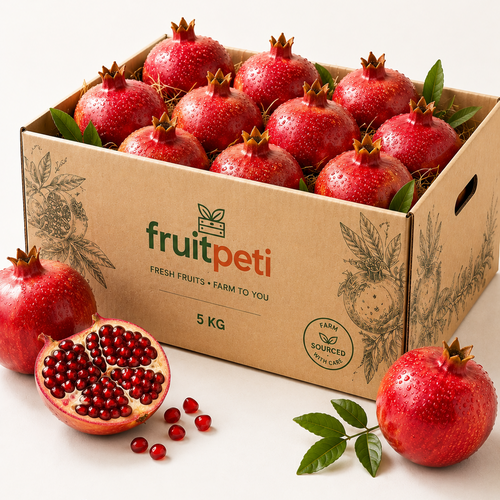 A 5 kg cardboard box of fresh pomegranates from FruitPeti, filled with whole and halved red pomegranates, displayed on a clean white background with promotional text and icons at the bottom.